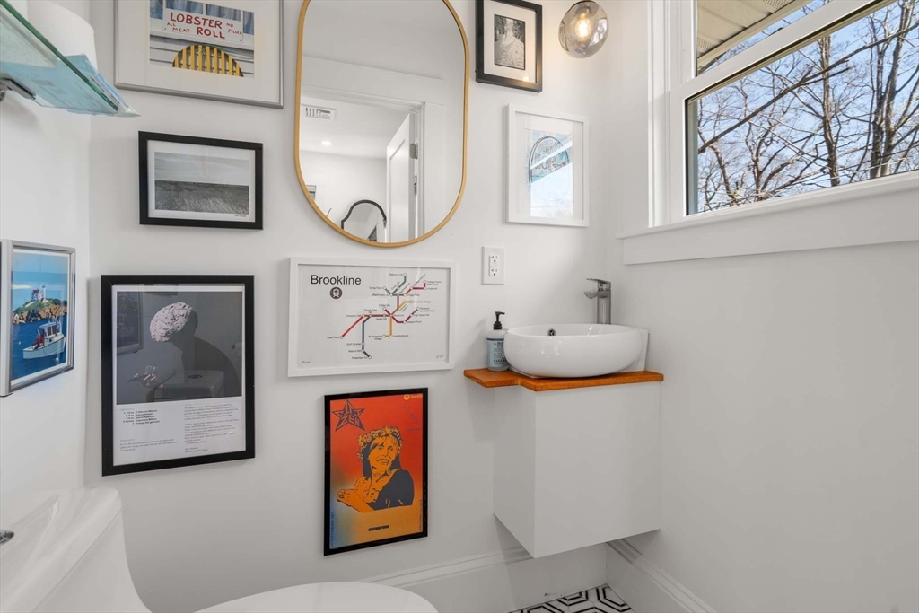 69 Henderson Street Needham, MA 02492 - Photo 16 of 26 a bathroom with a painting on the wall and a window