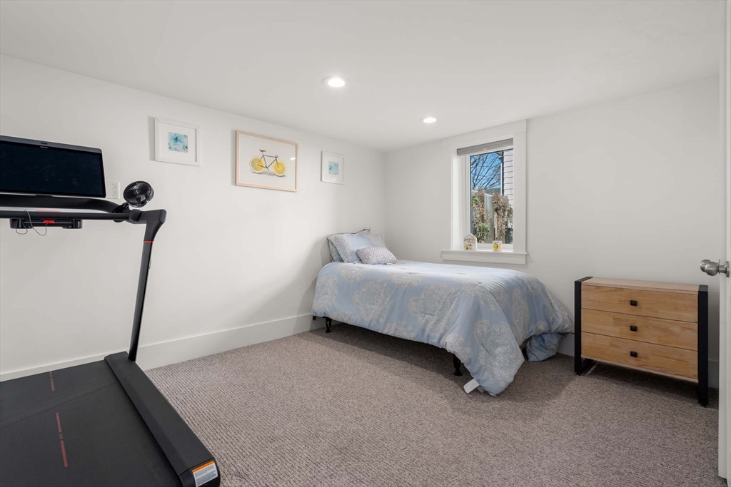 69 Henderson Street Needham, MA 02492 - Photo 20 of 26 a bedroom with a bed and a tv