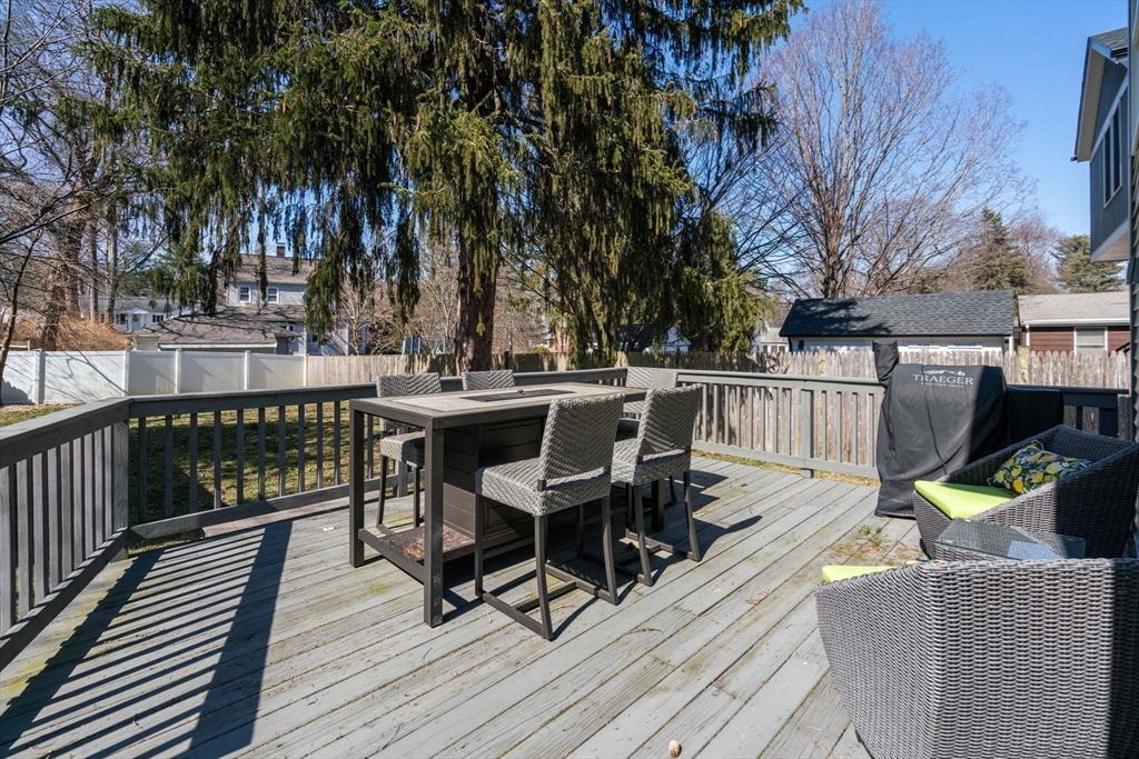 69 Henderson Street Needham, MA 02492 - Photo 24 of 26 a view of a deck with furniture and trees