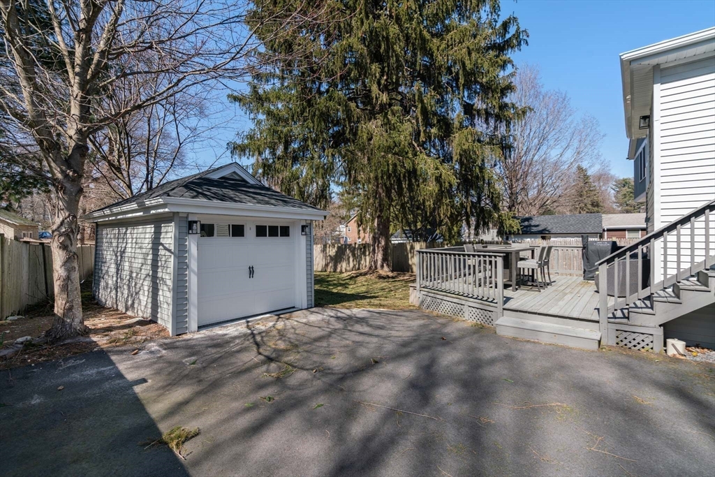 69 Henderson Street Needham, MA 02492 - Photo 25 of 26 a view of a house with a large tree and wooden fence