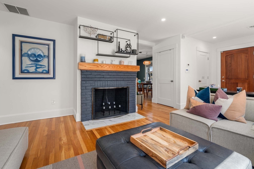 69 Henderson Street Needham, MA 02492 - Photo 5 of 26 a living room with furniture and a fireplace