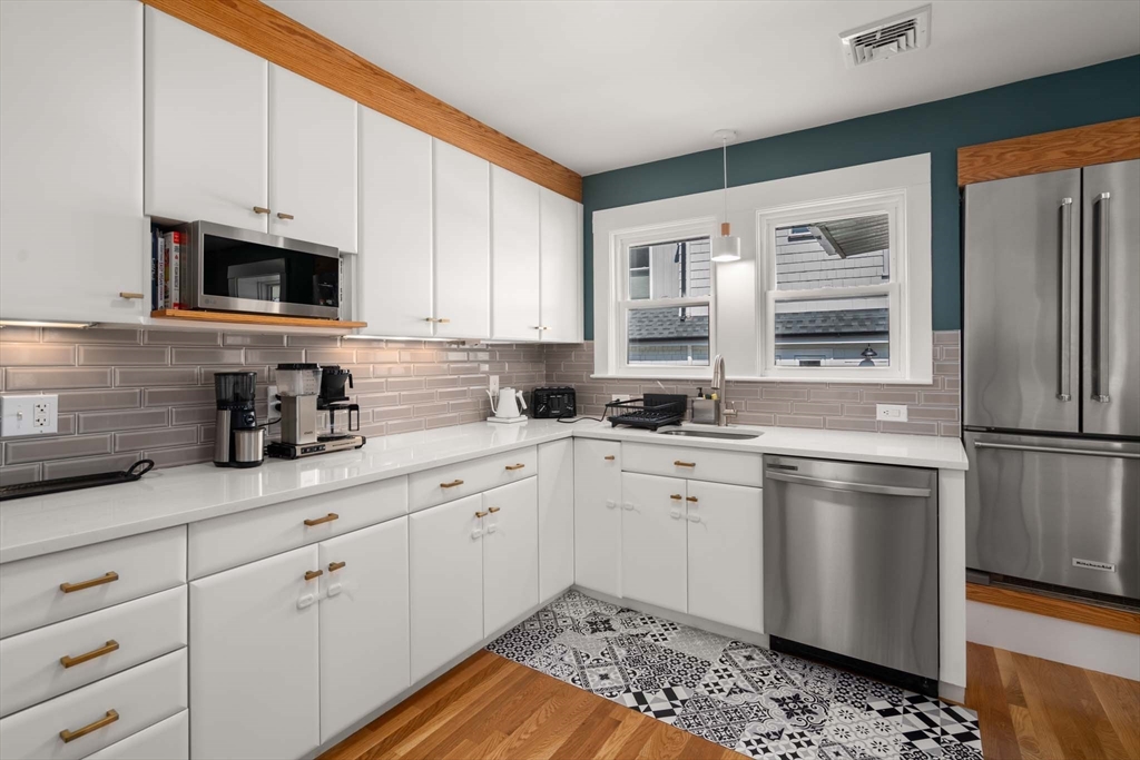 69 Henderson Street Needham, MA 02492 - Photo 8 of 26 a kitchen with granite countertop white cabinets white stainless steel appliances and sink