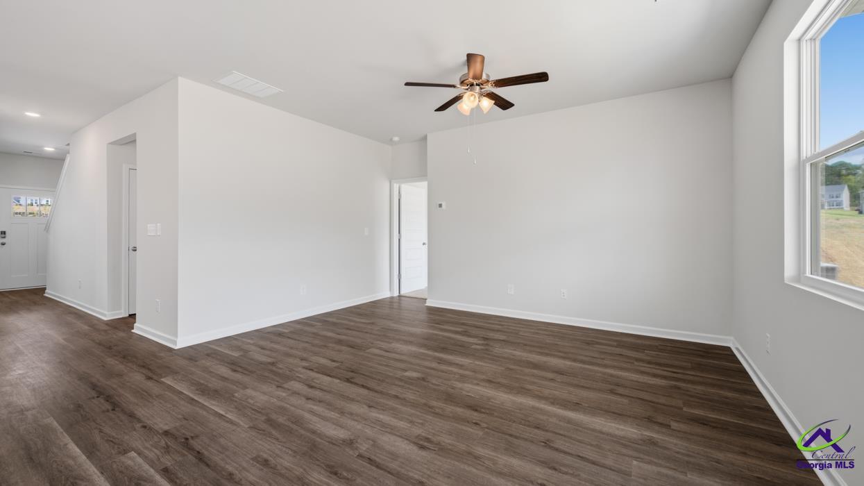 227 Cattle Drive Perry, GA 31069 - Photo 24 of 40 a view of empty room with wooden floor and fan