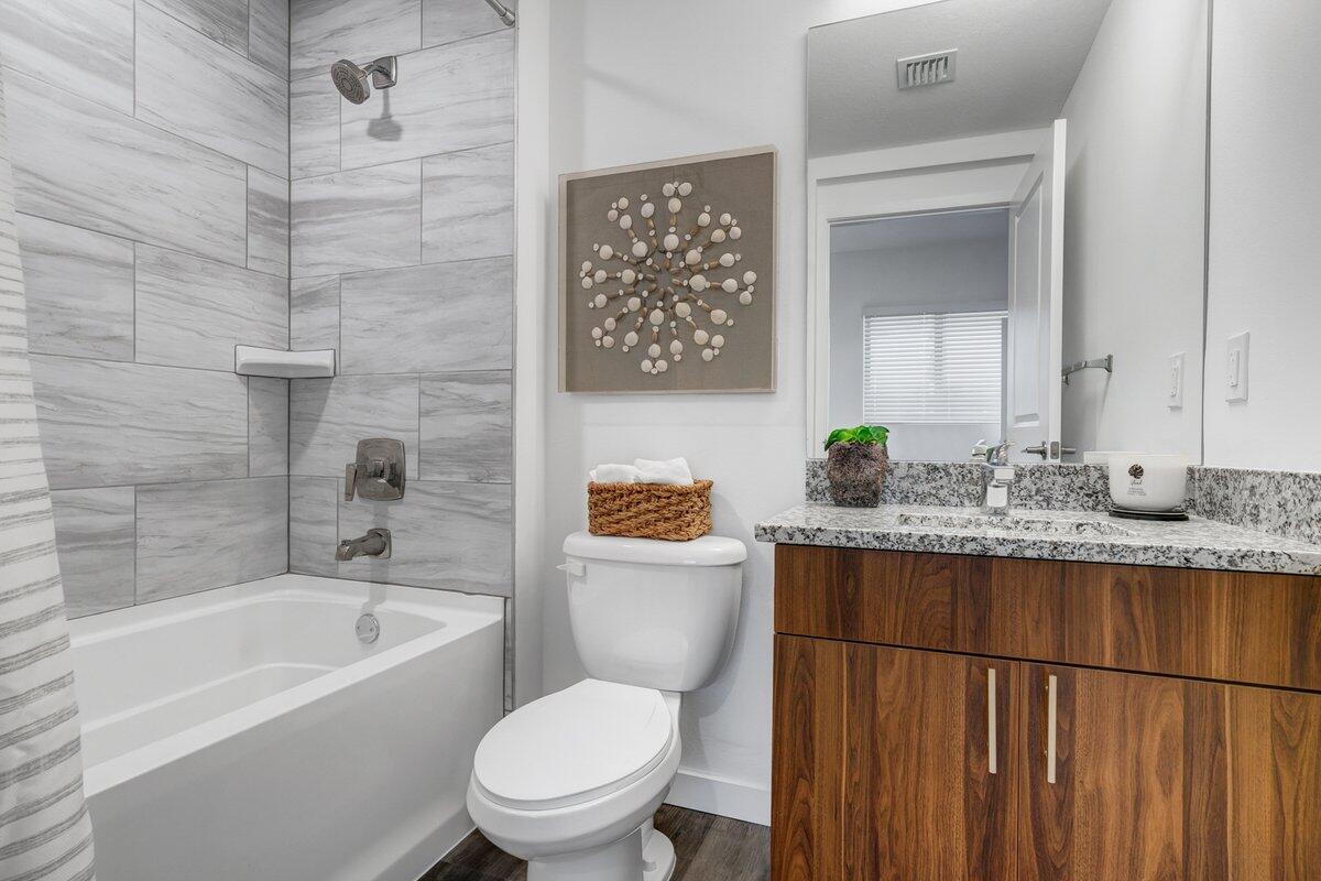 4250 Lakewood Road, Unit 101 Palm Springs, FL 33461 - Photo 11 of 20 a bathroom with a granite countertop toilet sink and bathtub