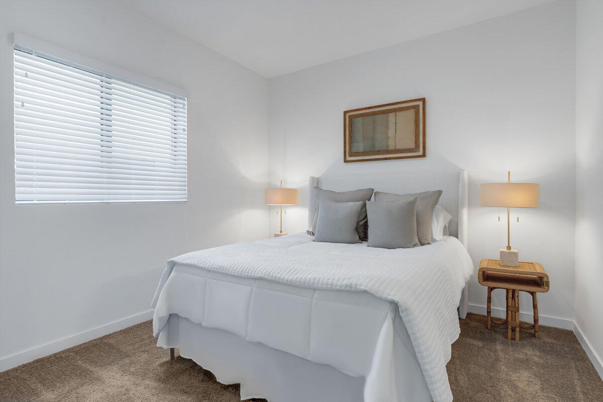 4250 Lakewood Road, Unit 101 Palm Springs, FL 33461 - Photo 15 of 20 a bedroom with a bed and a lamp
