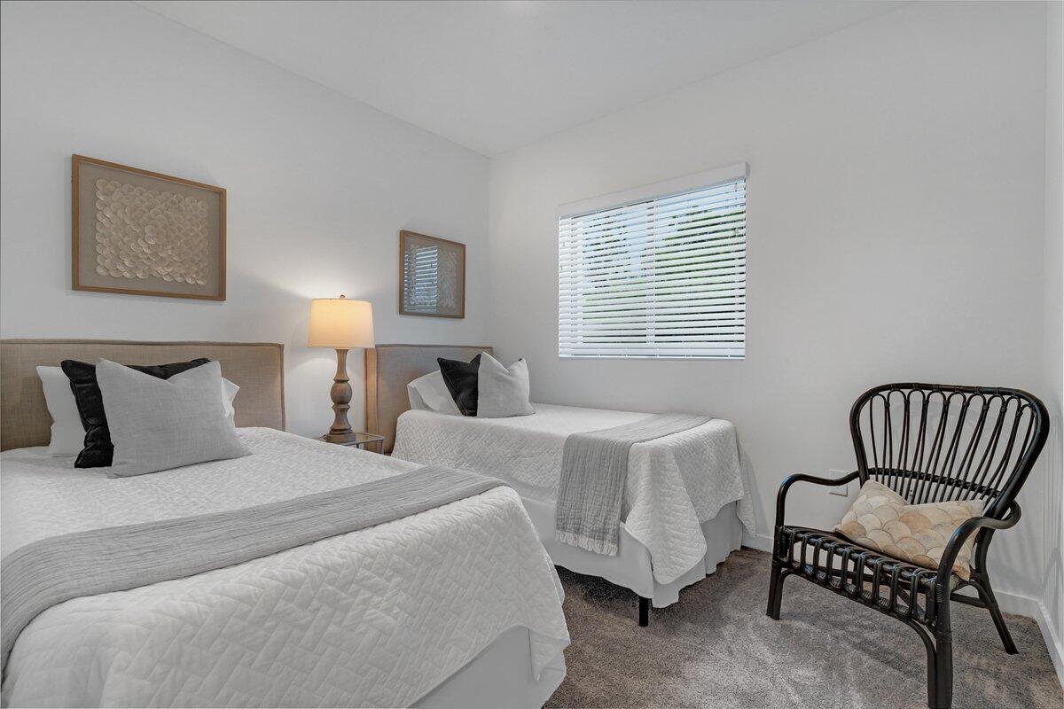 4250 Lakewood Road, Unit 101 Palm Springs, FL 33461 - Photo 7 of 20 a bedroom with two beds and a chair