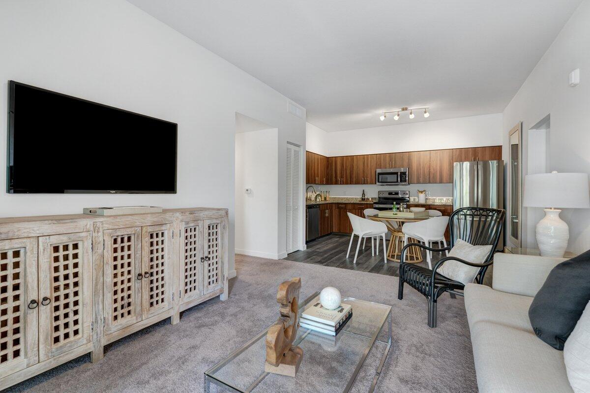 4250 Lakewood Road, Unit 101 Palm Springs, FL 33461 - Photo 10 of 20 a living room with furniture and a flat screen tv