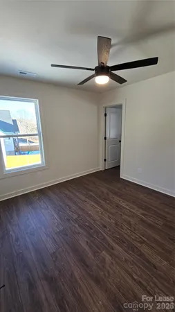 a spacious bathroom with a granite countertop toilet a sink and bathtub