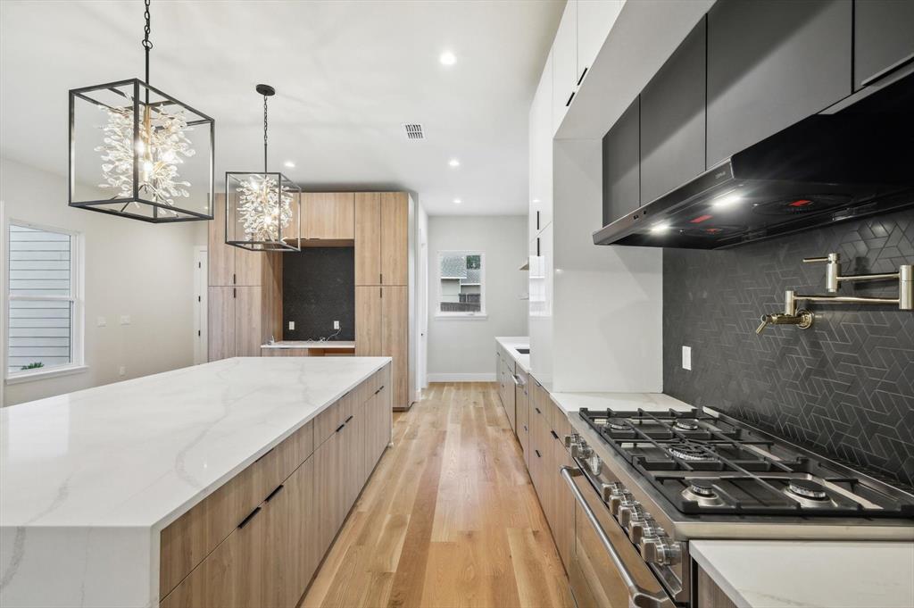 3902 Park Lane Dallas, TX 75220 - Photo 10 of 36 a kitchen with a stove and a wooden floor