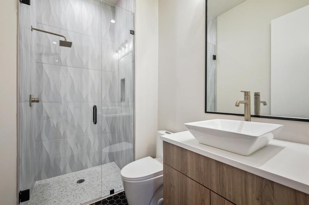 3902 Park Lane Dallas, TX 75220 - Photo 11 of 36 a bathroom with a sink a toilet and shower