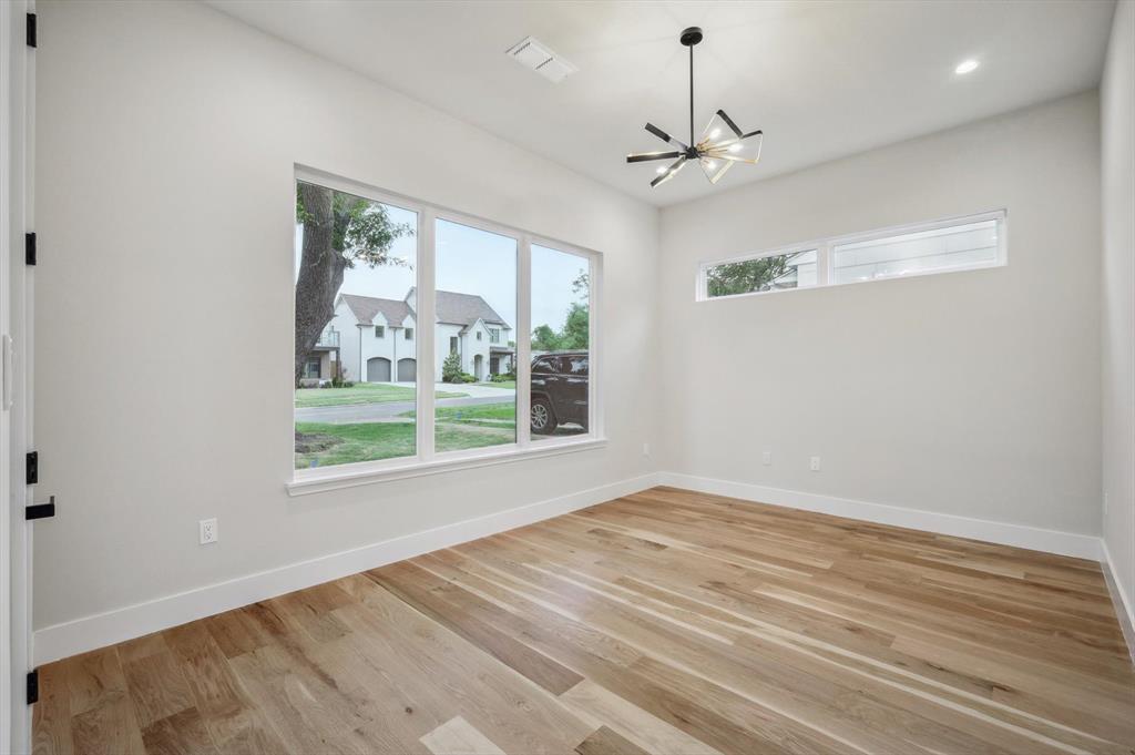 3902 Park Lane Dallas, TX 75220 - Photo 12 of 36 a view of an empty room with wooden floor and a window