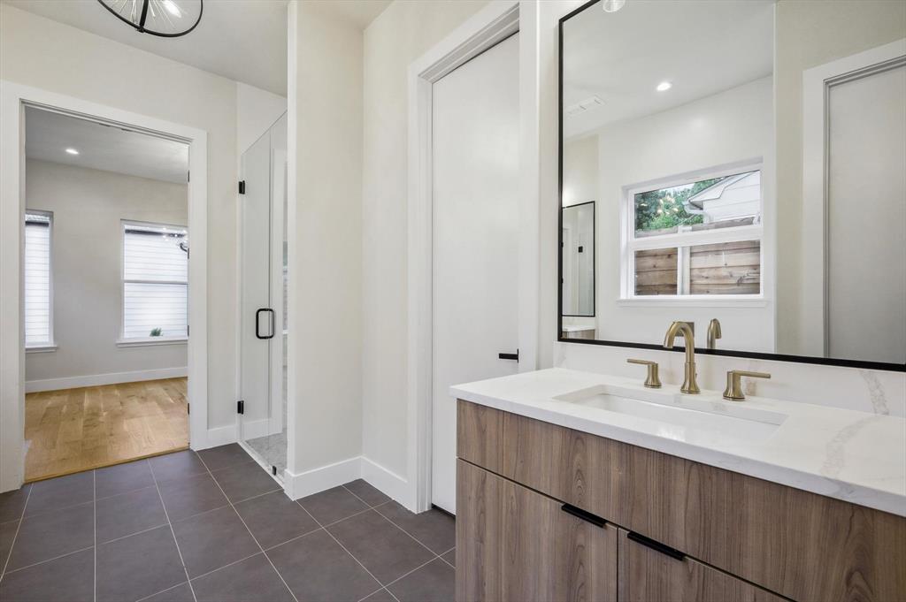 3902 Park Lane Dallas, TX 75220 - Photo 15 of 36 a bathroom with a sink a mirror and a bathtub