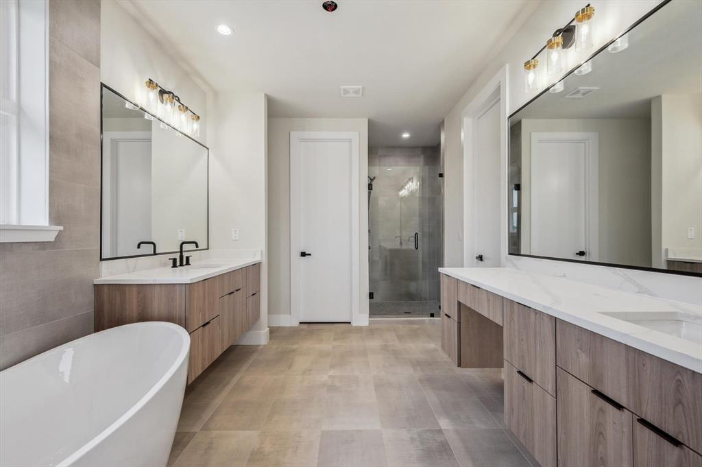 3902 Park Lane Dallas, TX 75220 - Photo 19 of 36 a bathroom with a tub a sink double vanity and a mirror