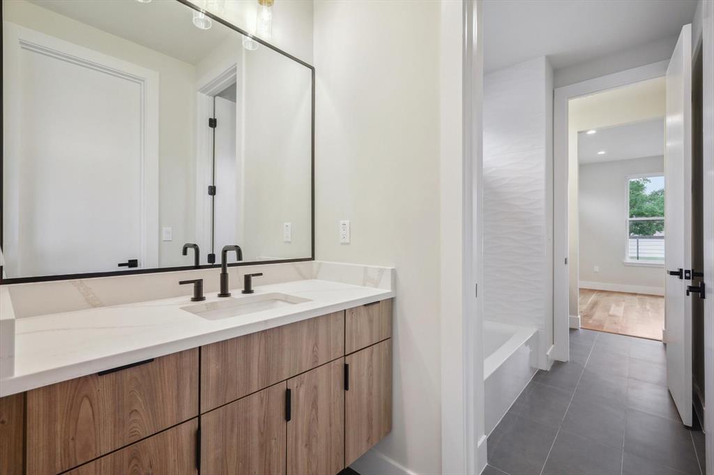 3902 Park Lane Dallas, TX 75220 - Photo 27 of 36 a bathroom with a sink and a mirror