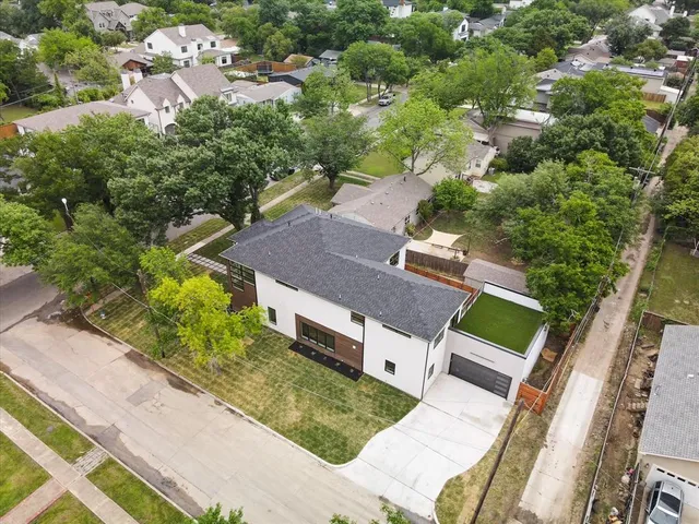 an aerial view of a house with a yard and lake view