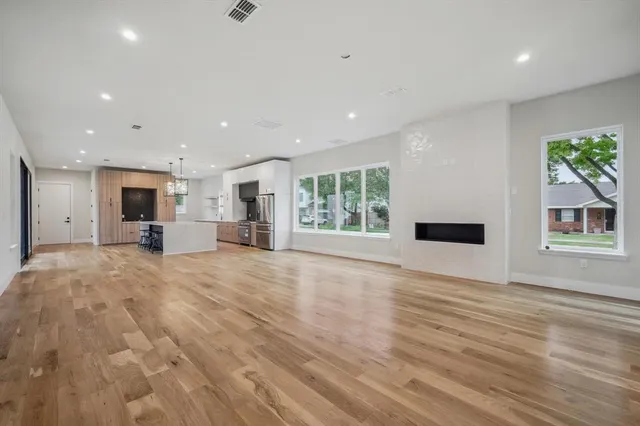 wooden floor in an empty room with a window