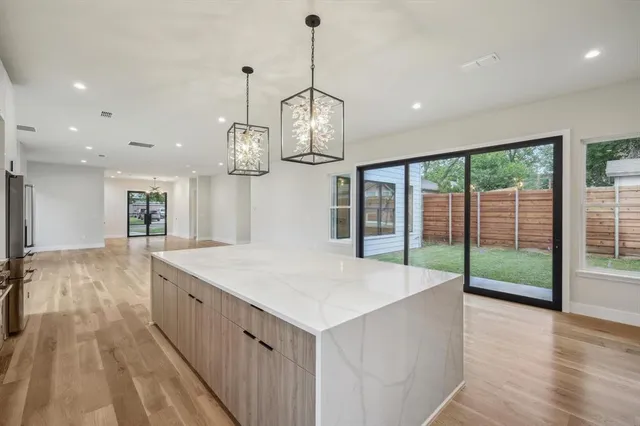 a large kitchen with a table and chairs