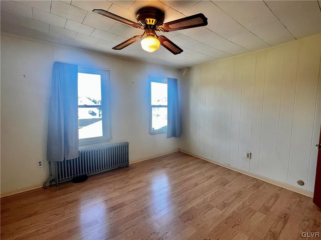 705 Main Street Stockertown, PA 18083 - Photo 14 of 23 an empty room with wooden floor fan and windows