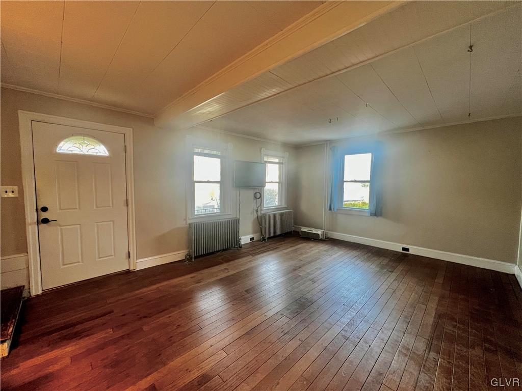 705 Main Street Stockertown, PA 18083 - Photo 3 of 23 an empty room with wooden floor and windows