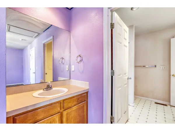a bathroom with a sink shower and a mirror