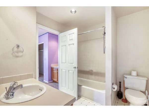 a bathroom with a sink toilet a mirror and shower