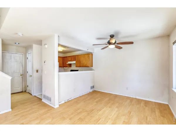 a view of empty room with wooden floor