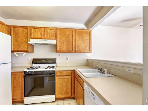 a kitchen with a stove a sink and a microwave