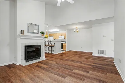 a view of empty room with wooden floor and fireplace