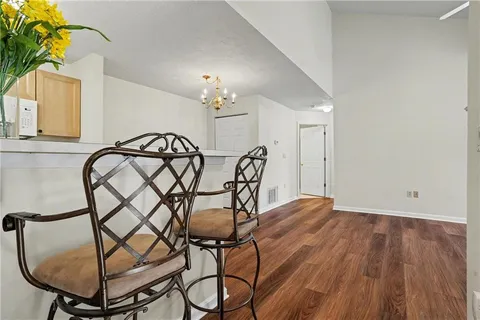 a view of a livingroom with furniture and chandelier fan