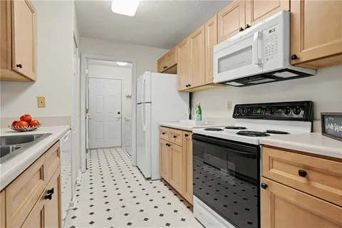 a kitchen with stainless steel appliances a stove a sink and a refrigerator