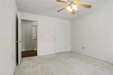 an empty room with closet and windows