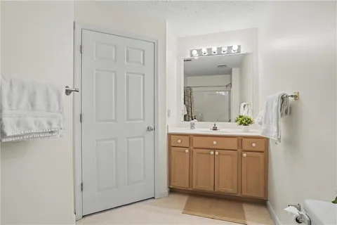 a bathroom with a sink vanity and a mirror