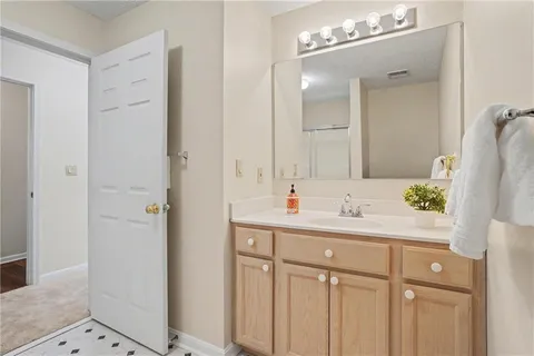 a bathroom with a sink vanity granite and a mirror