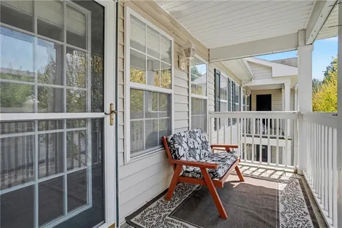 a balcony with table and chairs
