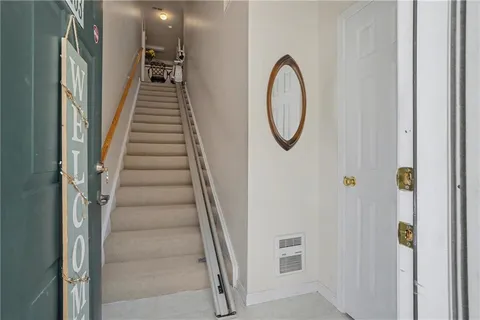 a view of a hallway with wooden floor and entryway