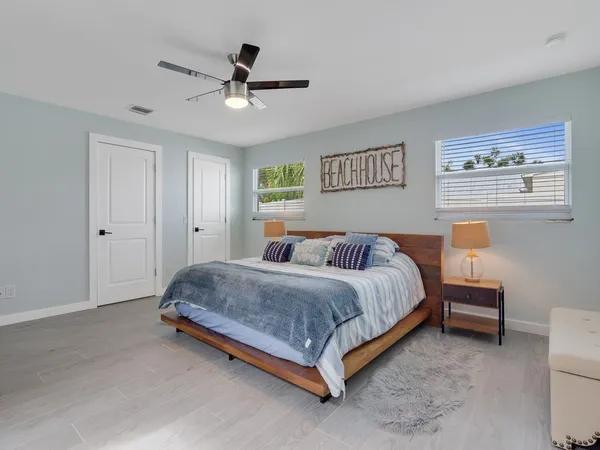 a spacious bedroom with a bed and a table