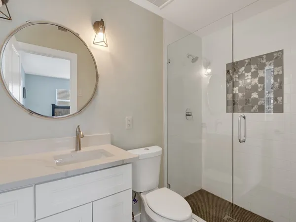 a bathroom with a toilet a sink and mirror