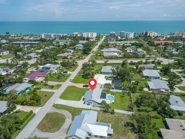 an aerial view of residential houses with outdoor space and swimming pool