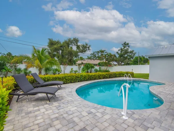 a view of a swimming pool with a yard