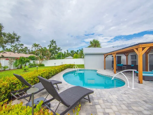 a view of swimming pool with lounge chair