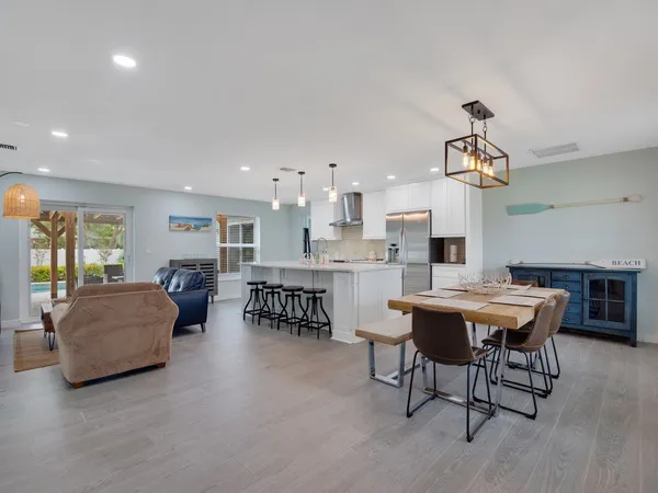 a view of a a dining room with furniture window and wooden floor