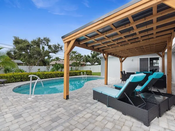 a view of a patio with a table and chairs