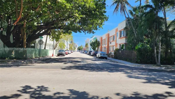 a couple of cars parked in front of a building