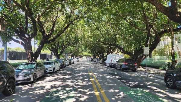 a view of a house with a tree in front