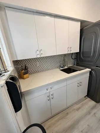 a view of a hallway with wooden floor and stairs