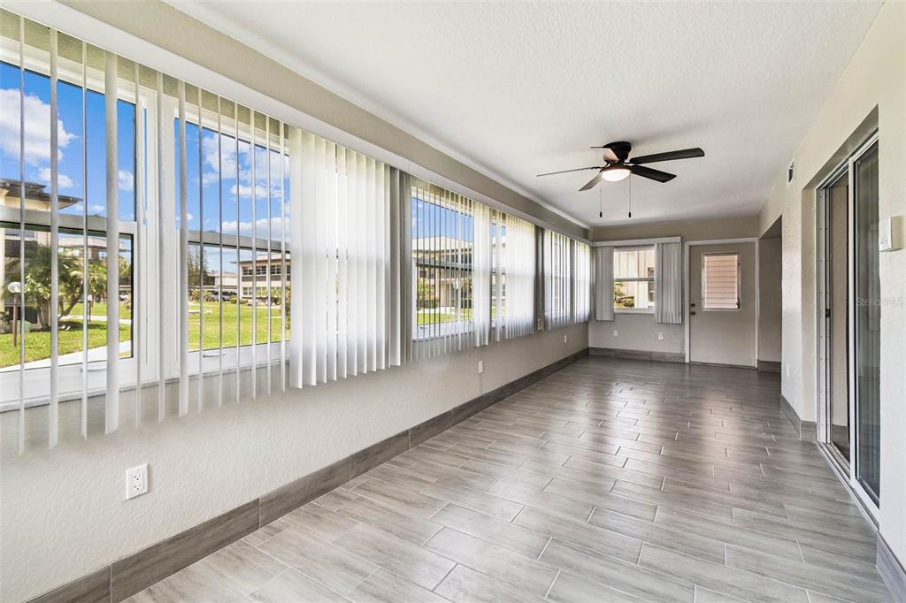4726 Marine Parkway, Unit 103 New Port Richey, FL 34652 - Photo 19 of 81 a view of an entryway with wooden floor and windows