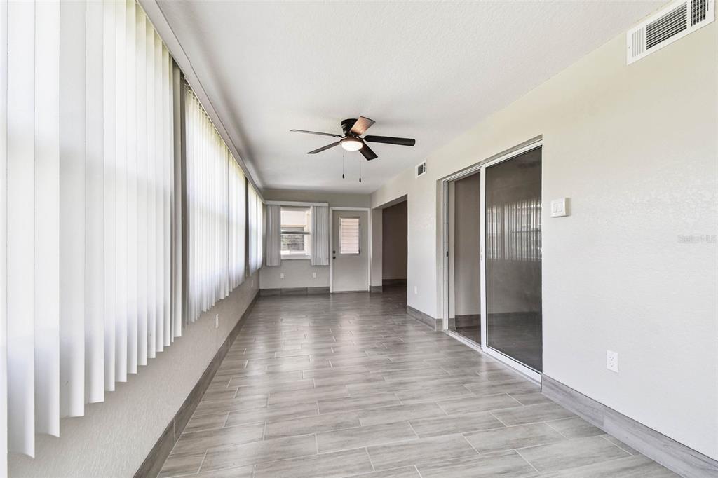 4726 Marine Parkway, Unit 103 New Port Richey, FL 34652 - Photo 20 of 81 a view of a hallway with wooden floor and a ceiling fan