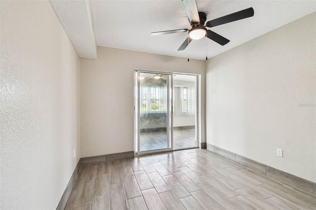 4726 Marine Parkway, Unit 103 New Port Richey, FL 34652 - Photo 25 of 81 an empty room with wooden floor and windows