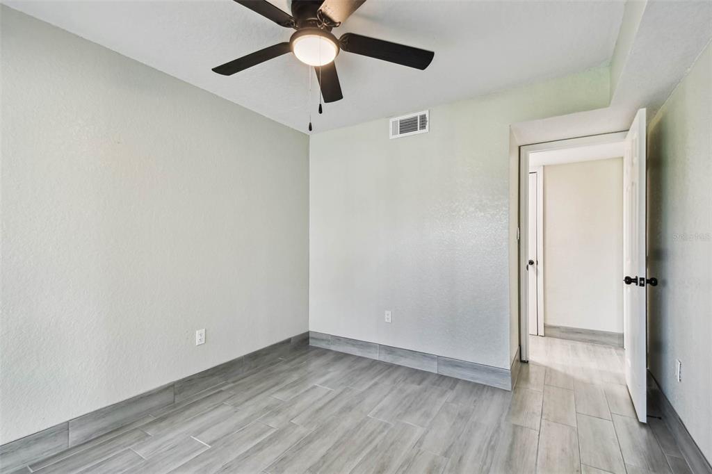4726 Marine Parkway, Unit 103 New Port Richey, FL 34652 - Photo 26 of 81 wooden floor in an empty room
