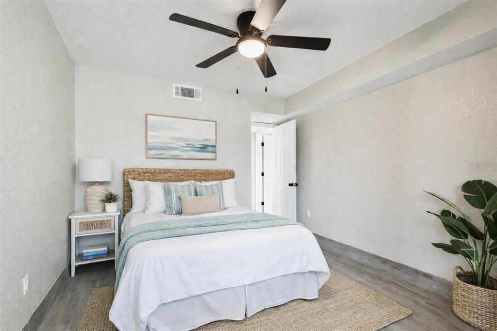 4726 Marine Parkway, Unit 103 New Port Richey, FL 34652 - Photo 27 of 81 a bedroom with a bed and a potted plant